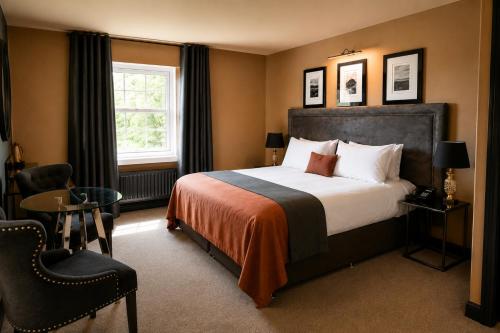 a hotel room with a bed and a window at The Fenwick Hotel in Kilmarnock