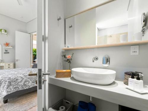 a bathroom with a sink and a bed at Himmelblau Boutique Bed and Breakfast in Cape Town