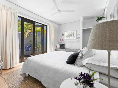 a bedroom with a bed and a large window at Himmelblau Boutique Bed and Breakfast in Cape Town