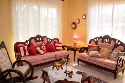 a living room with two couches and a table at Elegant Villa in Nagua with Private Pool and Jacuzzi in Nagua