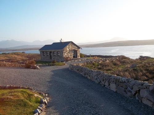 a stone church on the side of a road at Cill Cottage in Roundstone