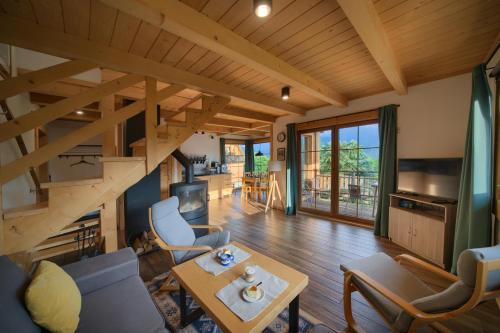 a living room with a spiral staircase in a house at Domek Pod Wierchami z Jacuzzi in Kościelisko