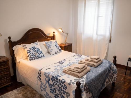 a bedroom with a bed with towels on it at Apartment with Mountain View in Eiriz – 65 sqm – Terrace in Eiriz