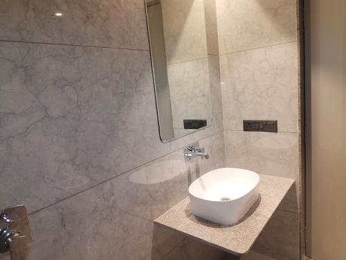 a bathroom with a toilet and a shower at Umbrellaa Hotels in Ahmedabad