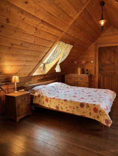 a bedroom with a bed in a wooden cabin at House of Aurora in Šwidnik