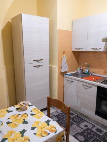 a kitchen with a table and a white refrigerator at Modern Studio in Catania with Air Conditioning in Catania