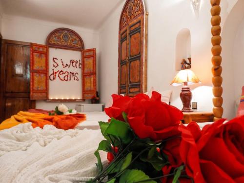a bedroom with a bed with red roses on it at Exceptional Villa in Marrakech with Private Pool in Marrakesh