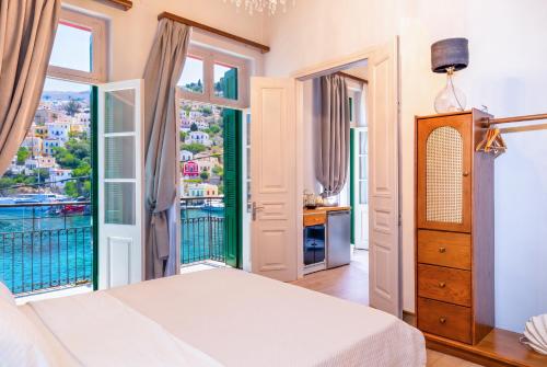 a bedroom with a bed and a large window at "LOS" 2 Neoclassic Harbour View in Symi