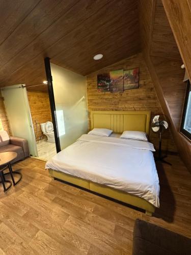 a large bed in a room with a wooden ceiling at arida farm peach in Bcharré