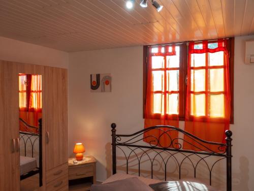 a bedroom with a bed and two windows at Appartement moderne avec vue mer à Bouillante, 50 m² in Bouillante