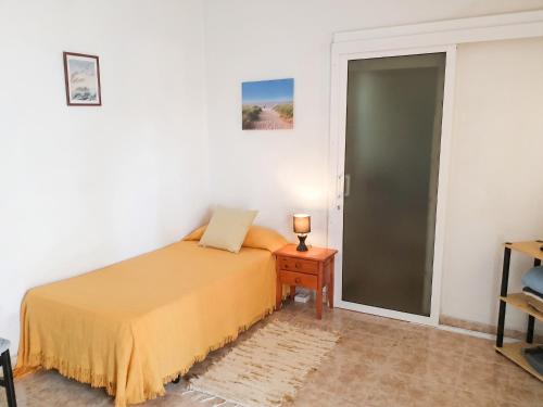 a bedroom with a bed and a glass door at Exceptional Studio in Frontera | 25 sq.m. | Terrace in Frontera