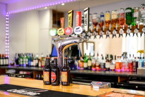 a bar with several bottles of beer on a counter at Bournemouth Sands Hotel in Bournemouth