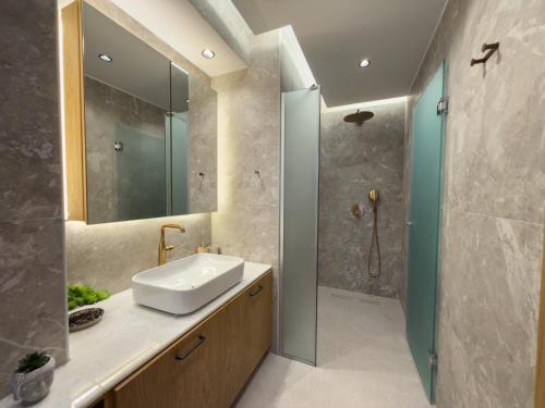 a bathroom with a sink and a shower at Marizon Suites - Adults Only in Vrachonisída touArchangélou