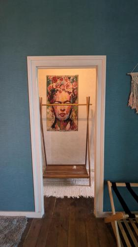 a mirror in a room with a picture of a cow at L'héritage in Champdeniers