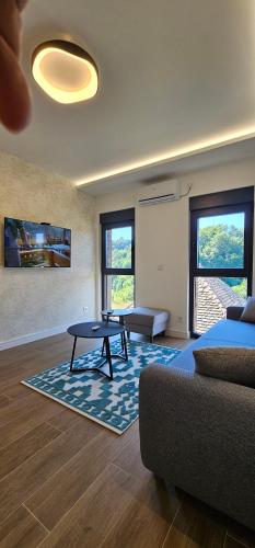 a living room with a table and a couch at Etno selo Azbuka in TrÅ¡iÄ‡
