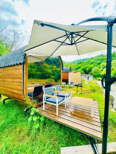 aented deck with chairs and an umbrella at Loft Dilijan in Dilijan