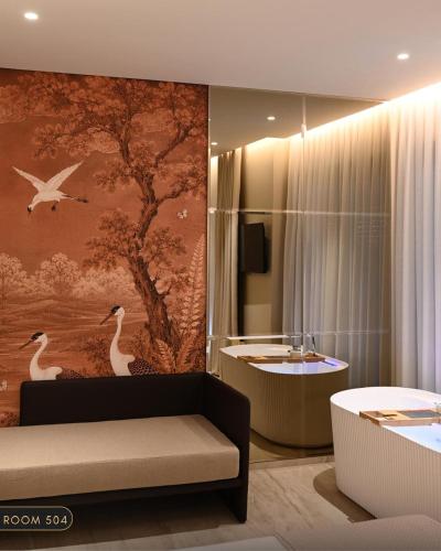 a living room with a couch and a bath tub at Elmares Hotel in Himare