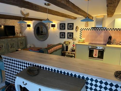 a kitchen and living room with a counter top at La Clé D'Alice in Montmorillon