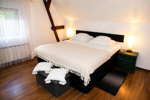 a bedroom with a large bed with two white pillows at 5 Stars in Jabłonka Stara