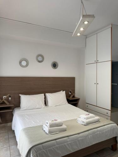 a bedroom with a bed with two towels on it at Zachos studio in Heraklio