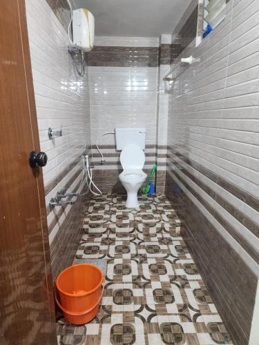a bathroom with a toilet on a mosaic tile floor at Mount View Attappadi in Agali
