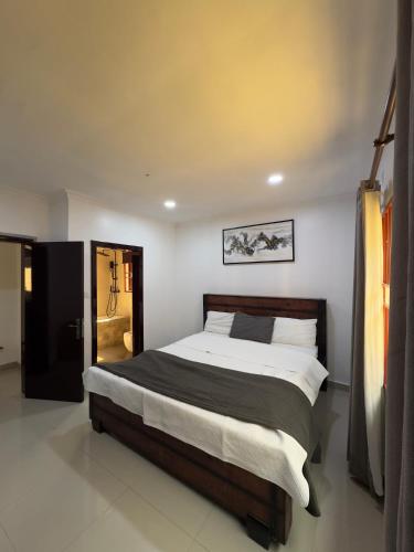 a bedroom with a large bed in a room at JAYNIEL Apartments #2 in Lusaka