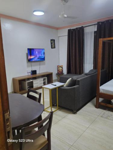 a living room with a couch and a table at Kim'sPlace in Mombasa