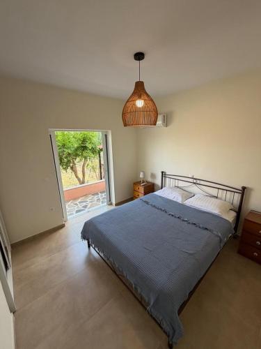 a bedroom with a bed and a pendant light at Pink House Eretria in Eretria