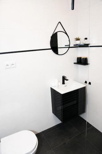 a white bathroom with a toilet and a sink at 5 Stars in Jabłonka Stara