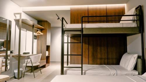 a room with two bunk beds and a desk at Eden Hotel in Rrogozhinë