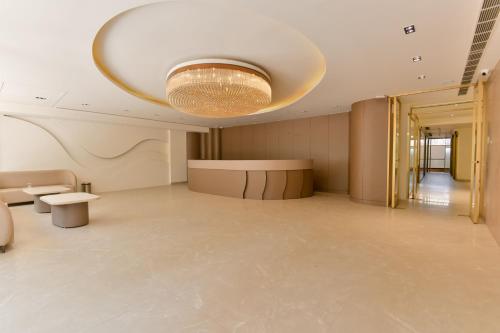 a lobby with a chandelier and a large room at Melange Hotel - Golf course road in Gurgaon