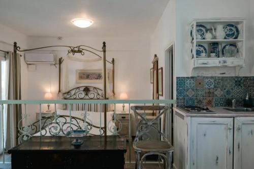 a kitchen with a glass table and chairs in it at Villa Areto in Kamares
