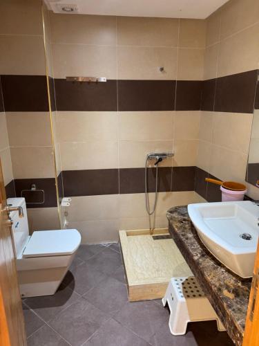 a bathroom with a sink and a toilet at Villa Savannah Beach in Sidi Rahal