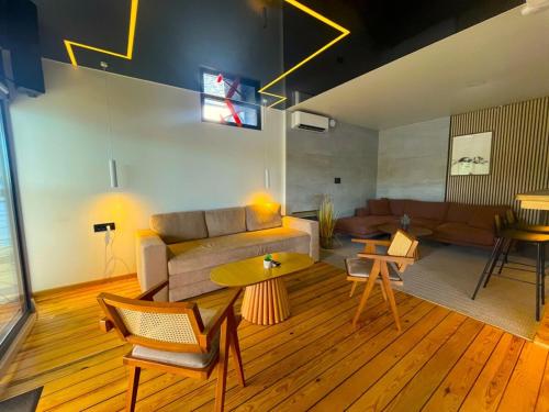 a living room with a couch and a table at Swan in Belgrade