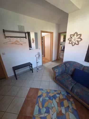 a living room with a couch and a table at Ferienwohnung Tirolerhof in Horn