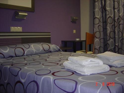 Кровать или кровати в номере Hostal Rica Posada