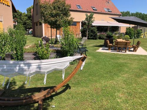 a hammock in the yard of a house at Les Loges Du Ried in Marckolsheim