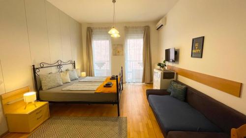 a bedroom with a bed and a couch in a room at Gellerico Apartments Wesselényi Street in Budapest