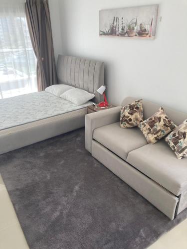 a living room with a couch and a bed at Caesar Resort spa in Dherinia