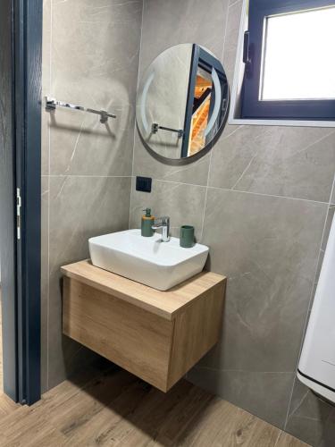 a bathroom with a sink and a mirror at V Chalet in Žabljak