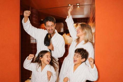 a group of people standing in a mirror with their arms up at Maison Arya in Brussels