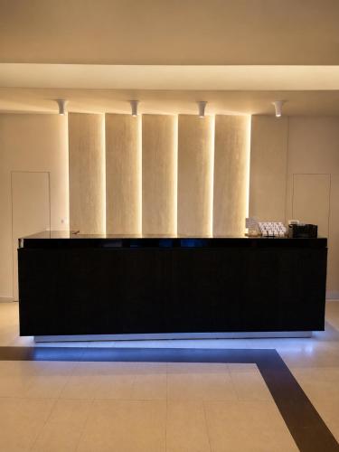 a large black counter in a room with columns at Hotel Gala in Cluj-Napoca