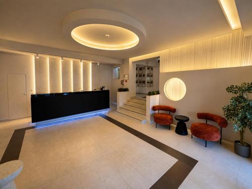 a lobby with chairs and a large screen at Hotel Gala in Cluj-Napoca