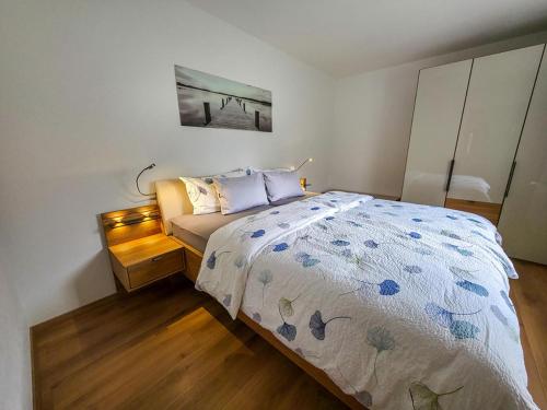 a small bedroom with a bed and a picture on the wall at Ferienwohnung Habit in Tschagguns