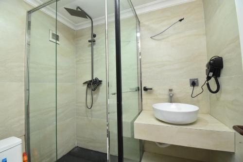 a bathroom with a shower and a sink at Residency by LMR in Kigali