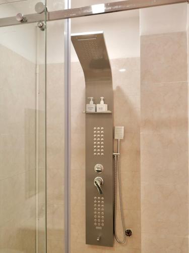 a shower in a bathroom with a glass door at Hila Hotel Vạn Ninh in Vạn Ninh