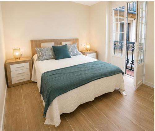 a bedroom with a large bed with two night stands at Residencial Junceda in Viveiro