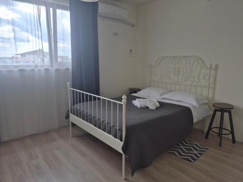 a bedroom with a bed with a crib in it at Tom House in Otopenii de Jos