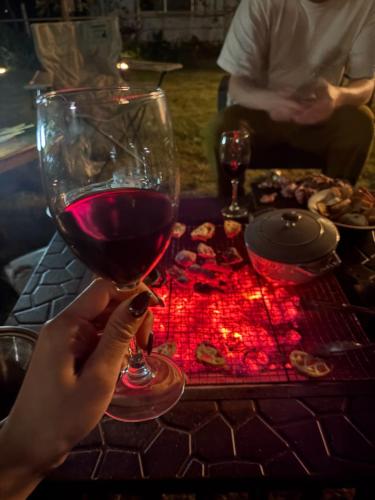 a person holding a glass of wine on a table at Haruhiya in Ishigaki Island