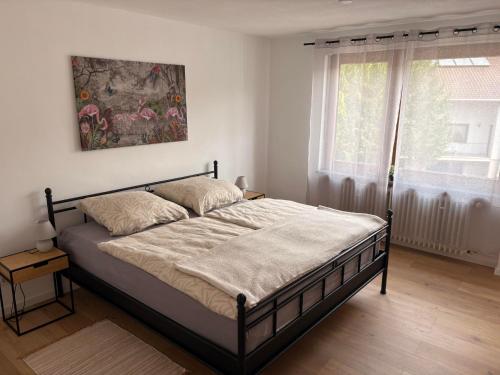 a bedroom with a bed and a window at Ferienwohnung Arend in Nonnweiler